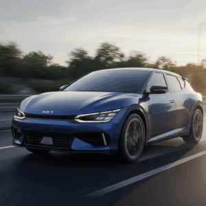 2025 Kia EV6 GT driving on an open highway with sleek green exterior