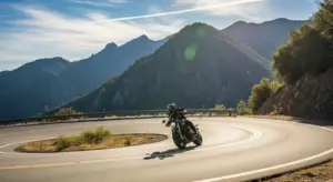 Rider confidently leaning motorcycle through a mountain turn.