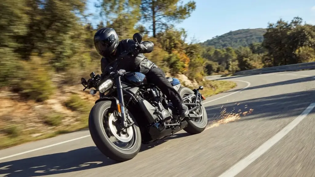 Rider leaning aggressively into a curve on the Sportster S
