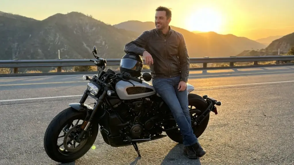 Rider parked beside the Sportster S near a mountain lookout